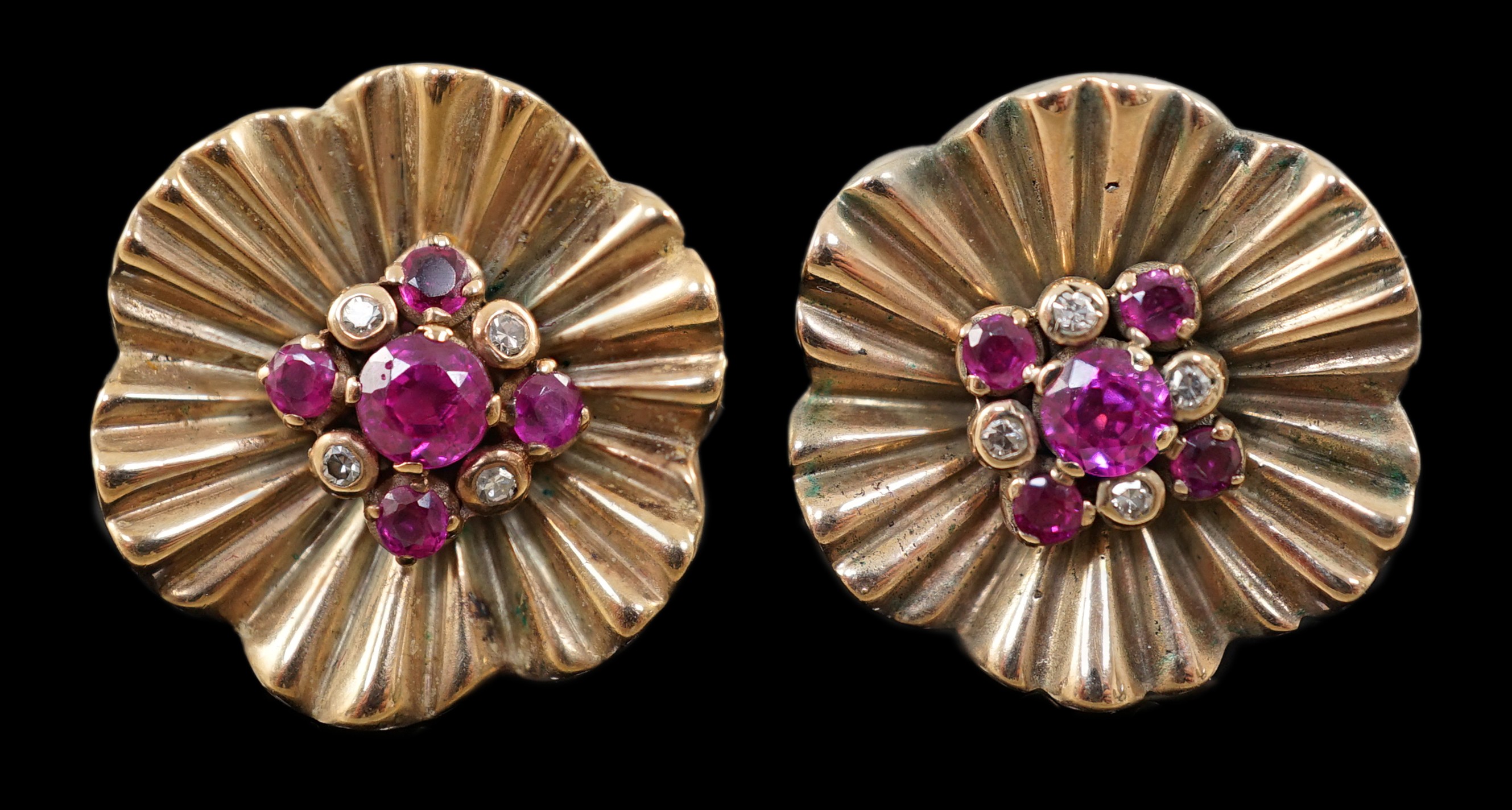 A pair of 1950's gold, ruby and diamond cluster set flower head earrings